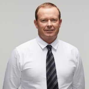 Peter B's story Image of current police officer looking at camera wearing white shirt with black and grey stripped tie; white male late thirties early forties